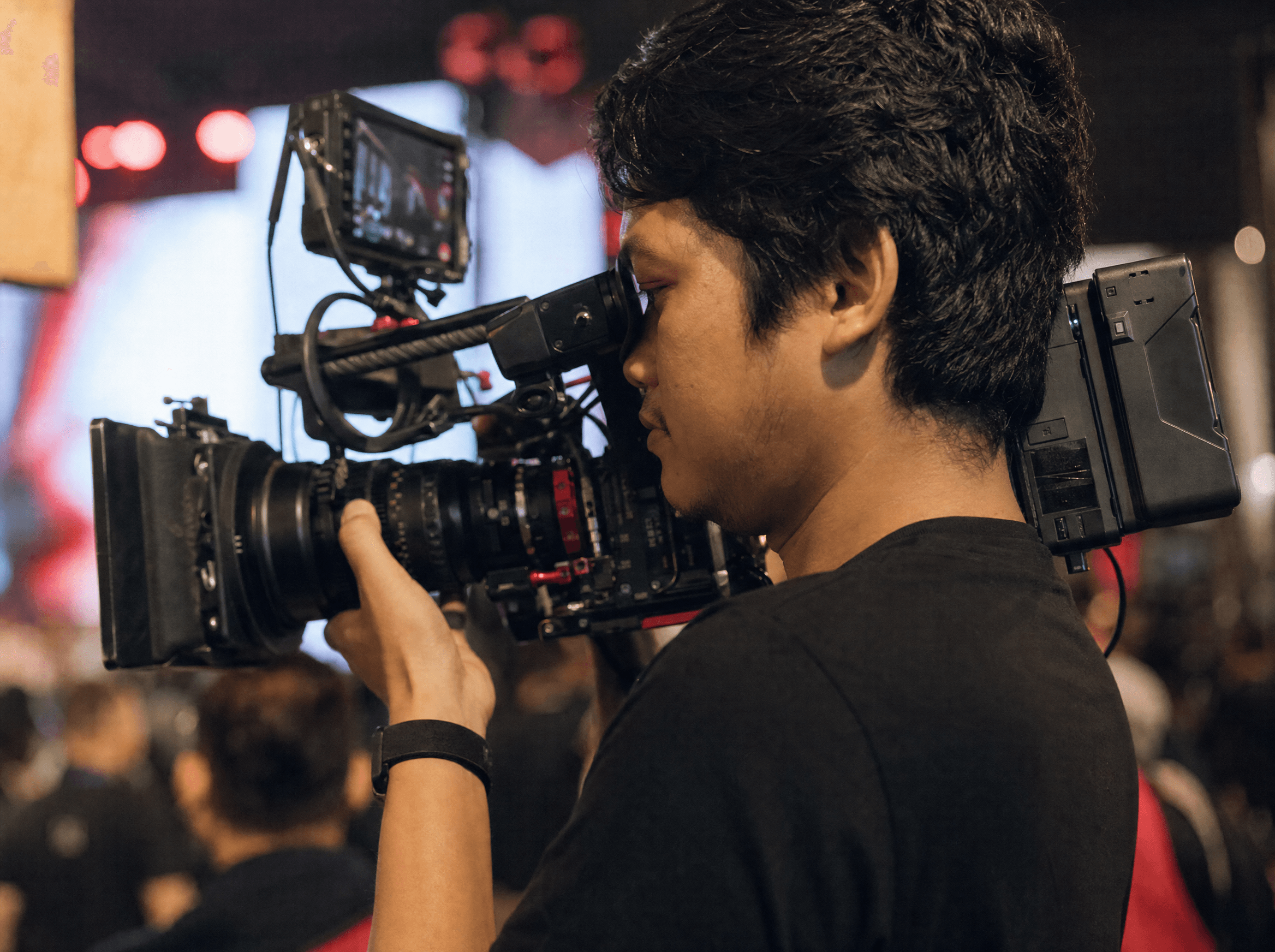 Indonesian camera operator filming a live event