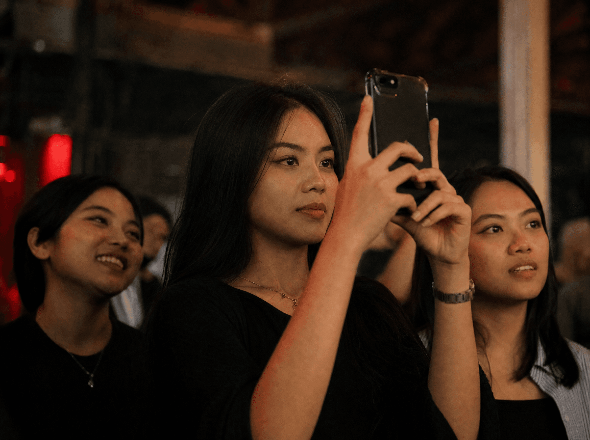 Indonesian audience member recording an event by phone