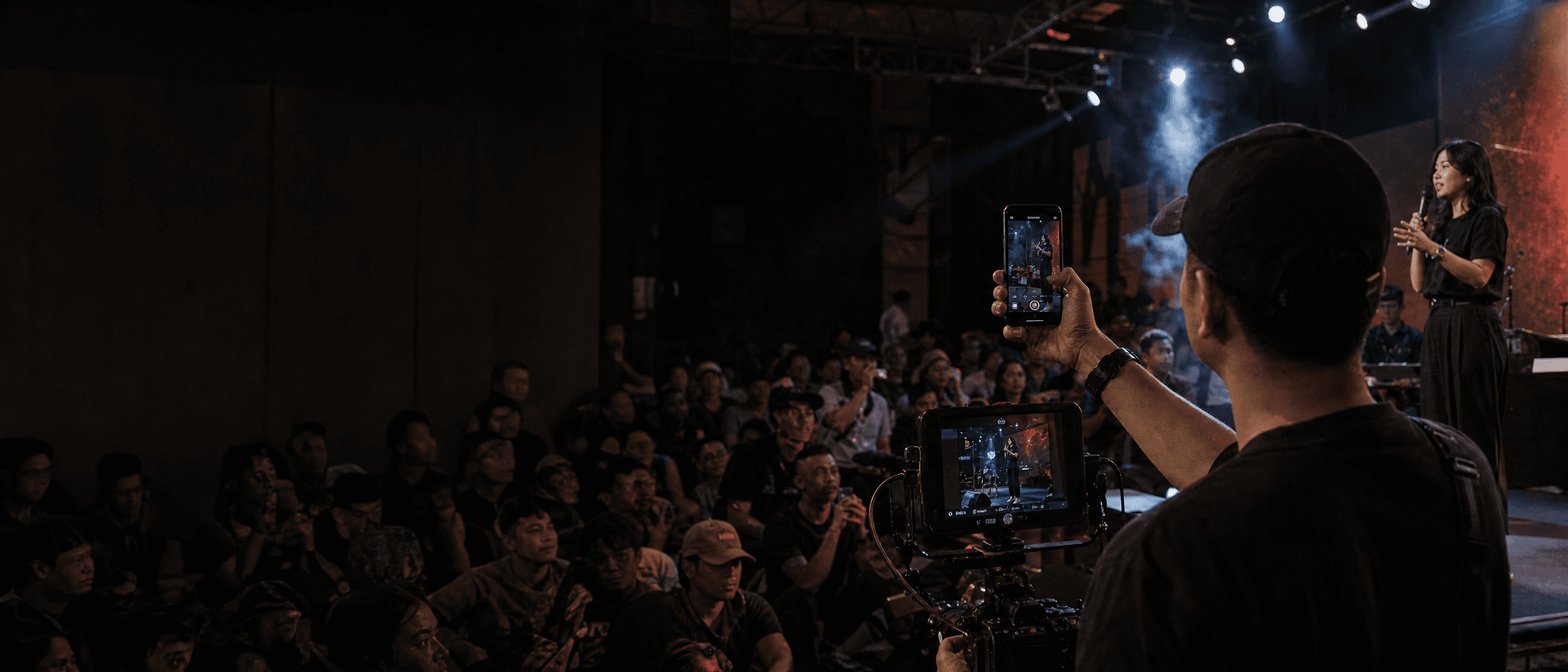 Camera operator filming a live cultural event in Jakarta